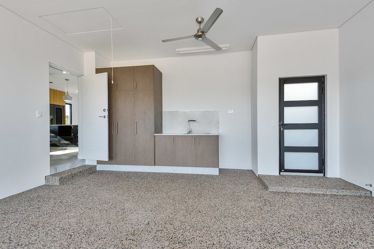An empty room with a ceiling fan and a door