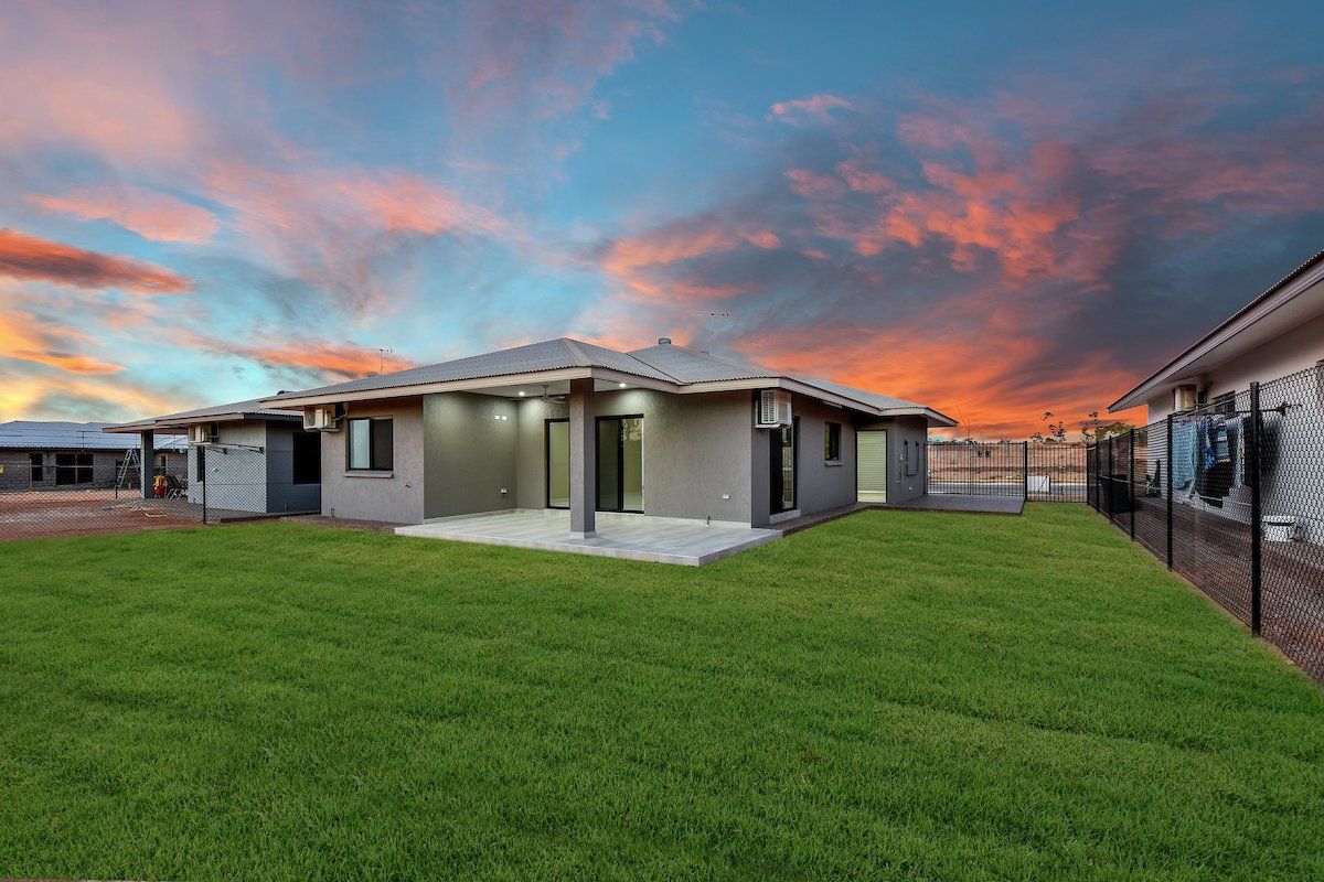 A house with a large lawn in front of it.