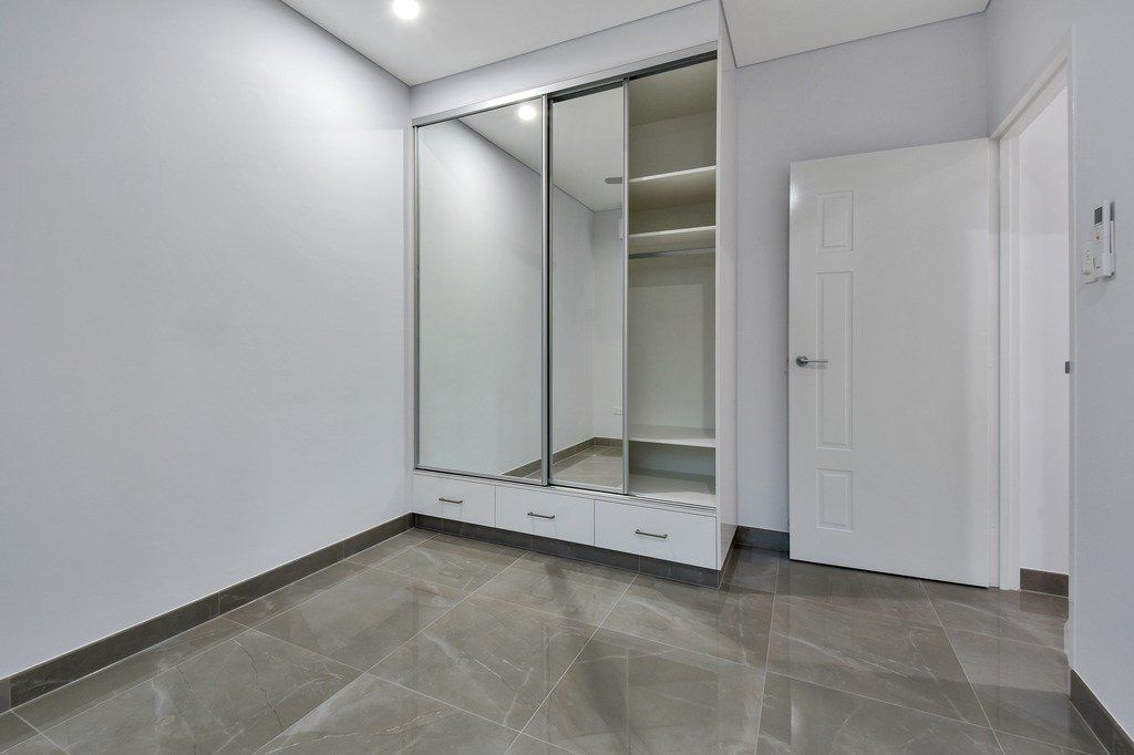 An empty room with a large mirror on the wall.