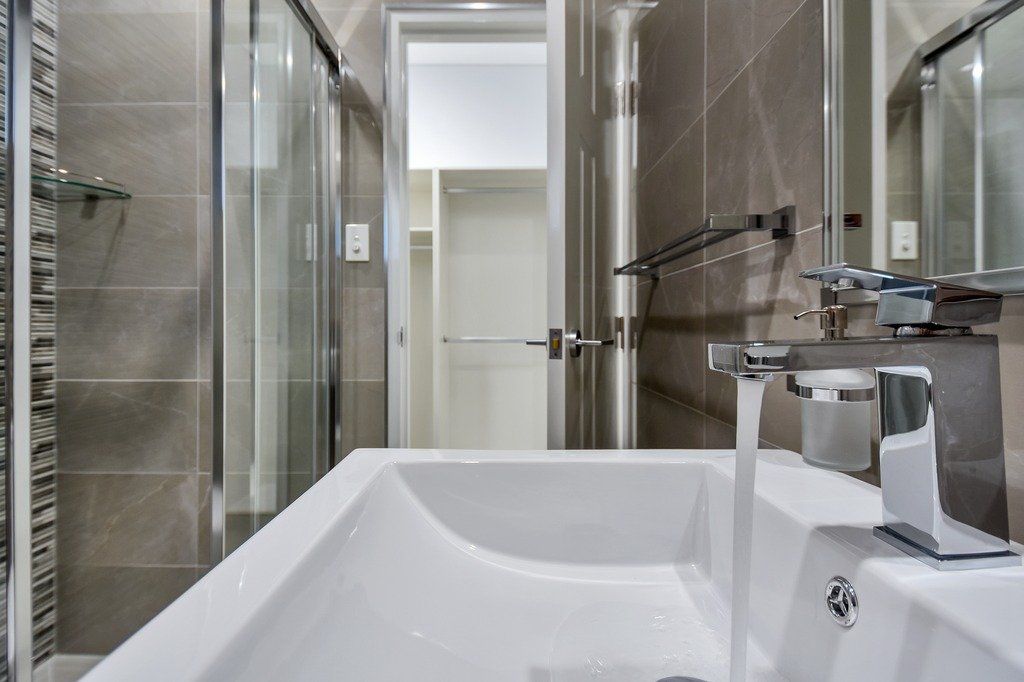 A bathroom with a sink , tub and shower.