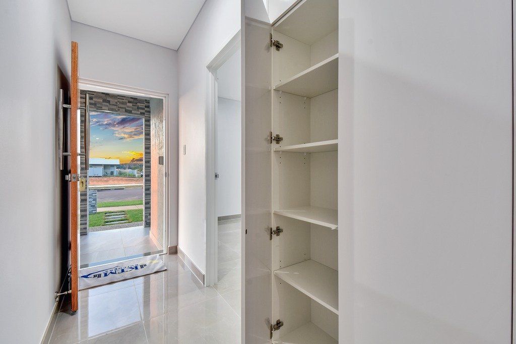 A hallway with a closet and a door in a house.