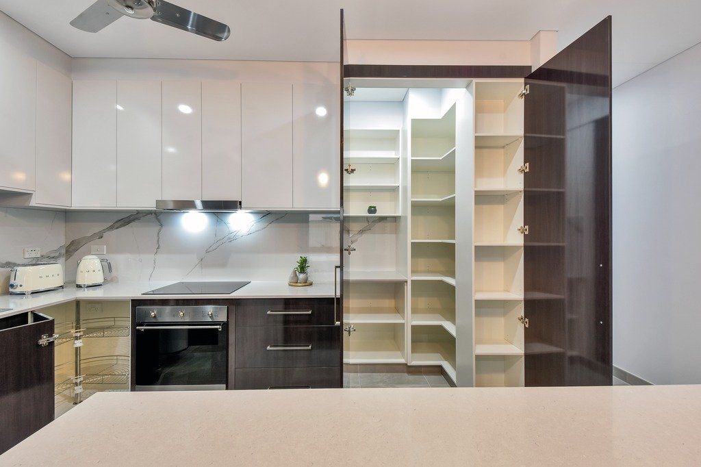 A kitchen with a pantry and a ceiling fan
