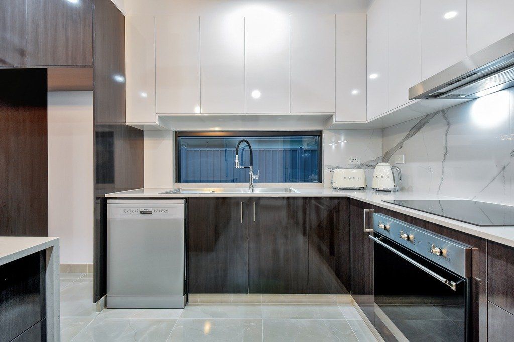 A kitchen with stainless steel appliances and wooden cabinets.