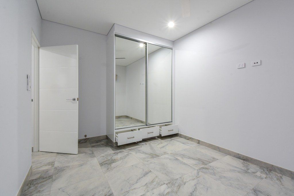 There is a large mirrored wardrobe in the middle of the room.