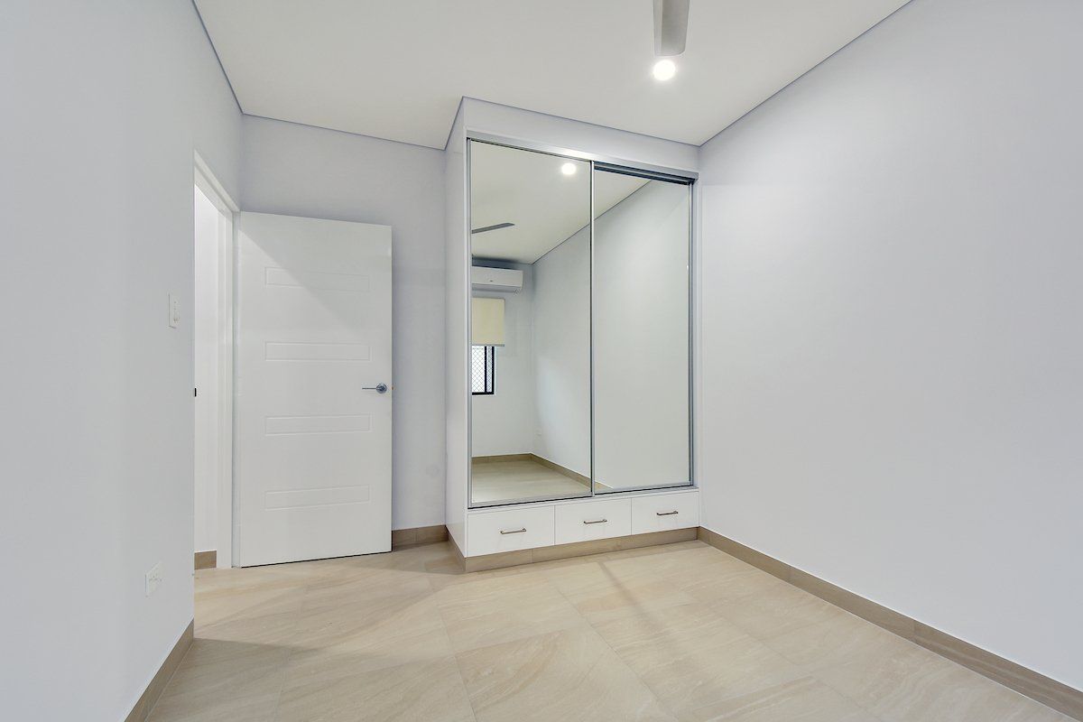 There is a large mirror in the corner of the room.