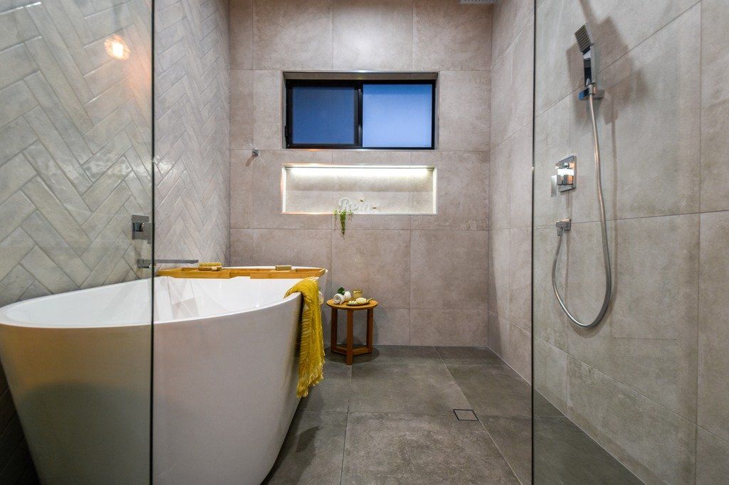 A bathroom with a bathtub and a walk in shower.