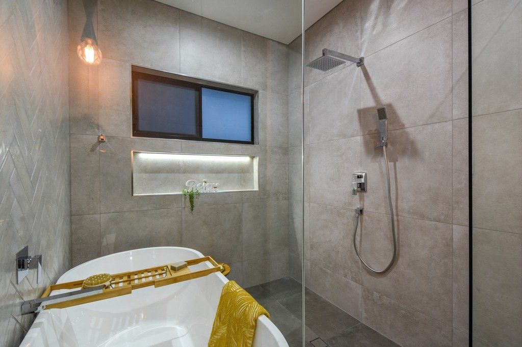 A bathroom with a bathtub and a walk in shower.