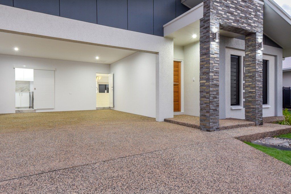 A house with a large driveway and a large garage.