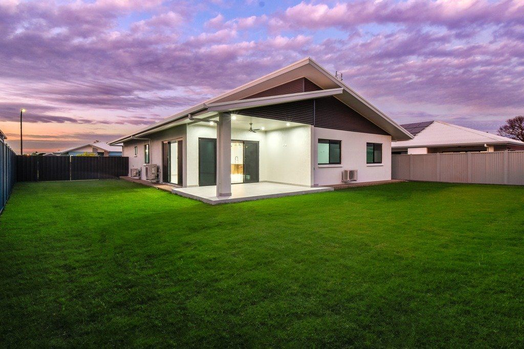 A house with a large lawn in front of it.