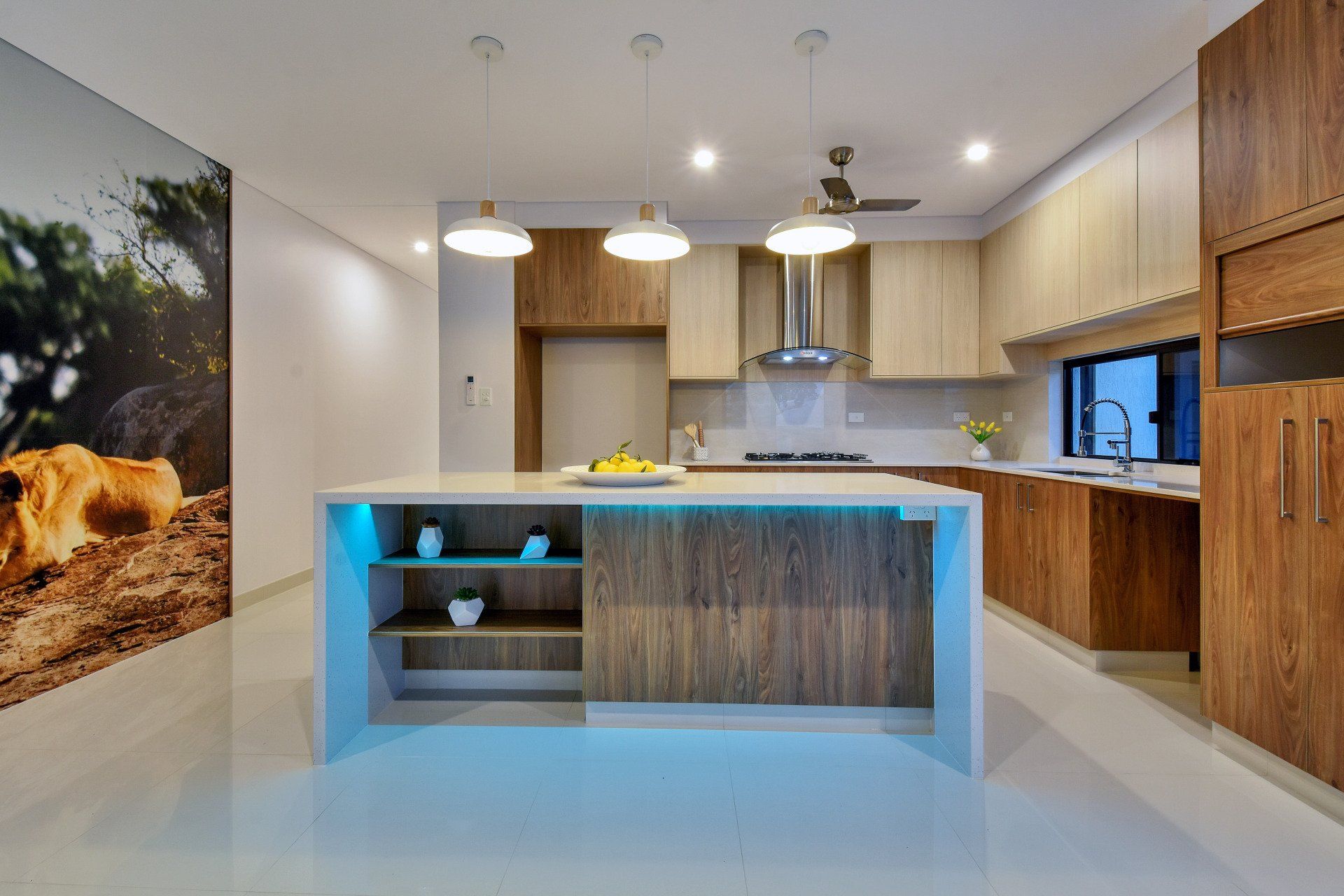 A kitchen with a large island and a picture of a lion on the wall.