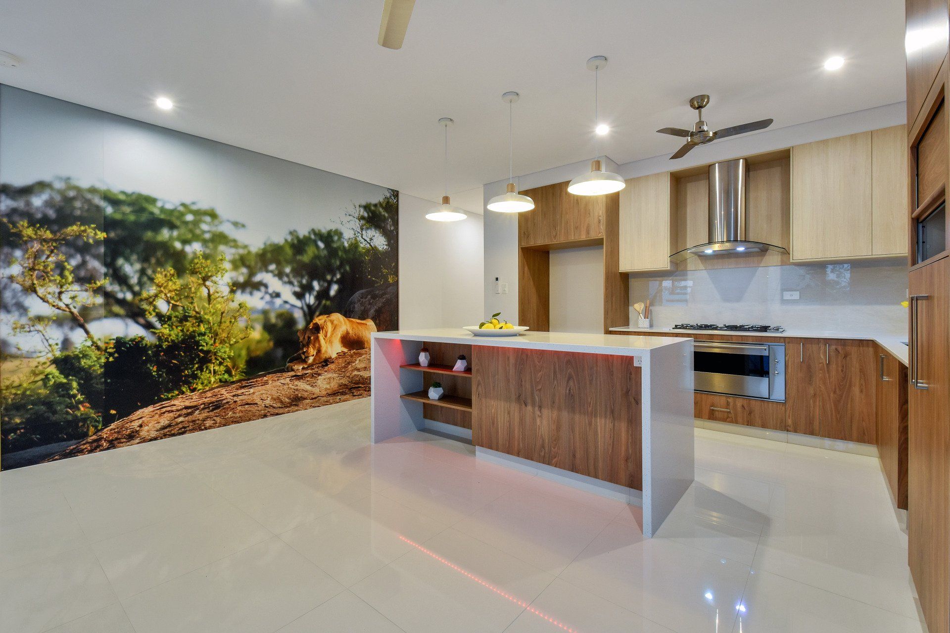 A kitchen with a large island and a painting on the wall.