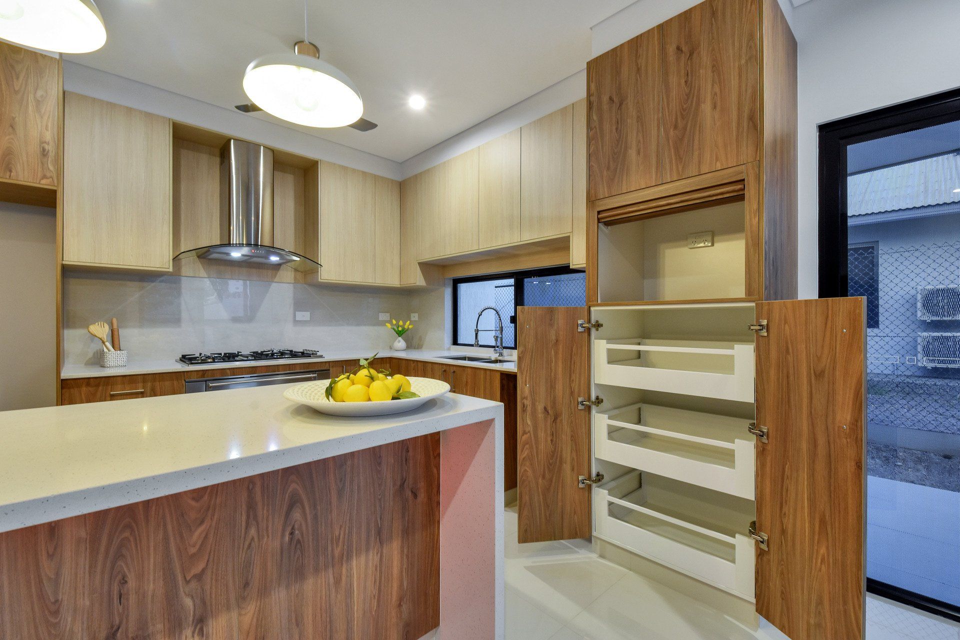 A kitchen with wooden cabinets and a sliding glass door.