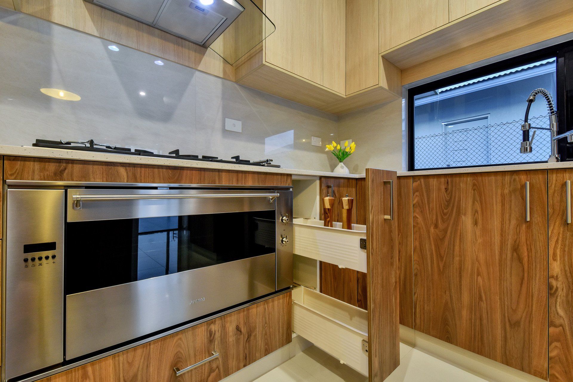 A kitchen with stainless steel appliances and wooden cabinets