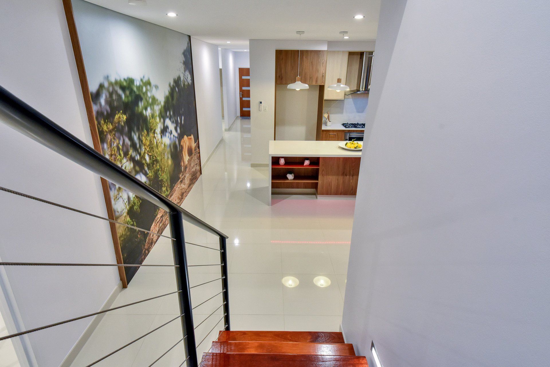 A view of a kitchen and stairs from the second floor