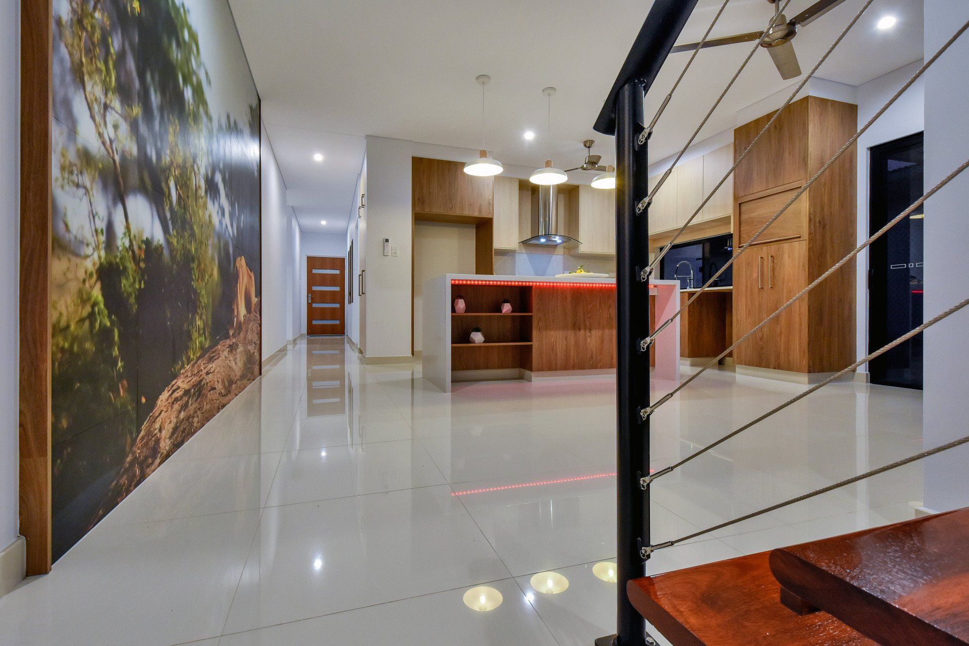 A view of a kitchen from a staircase in a house.