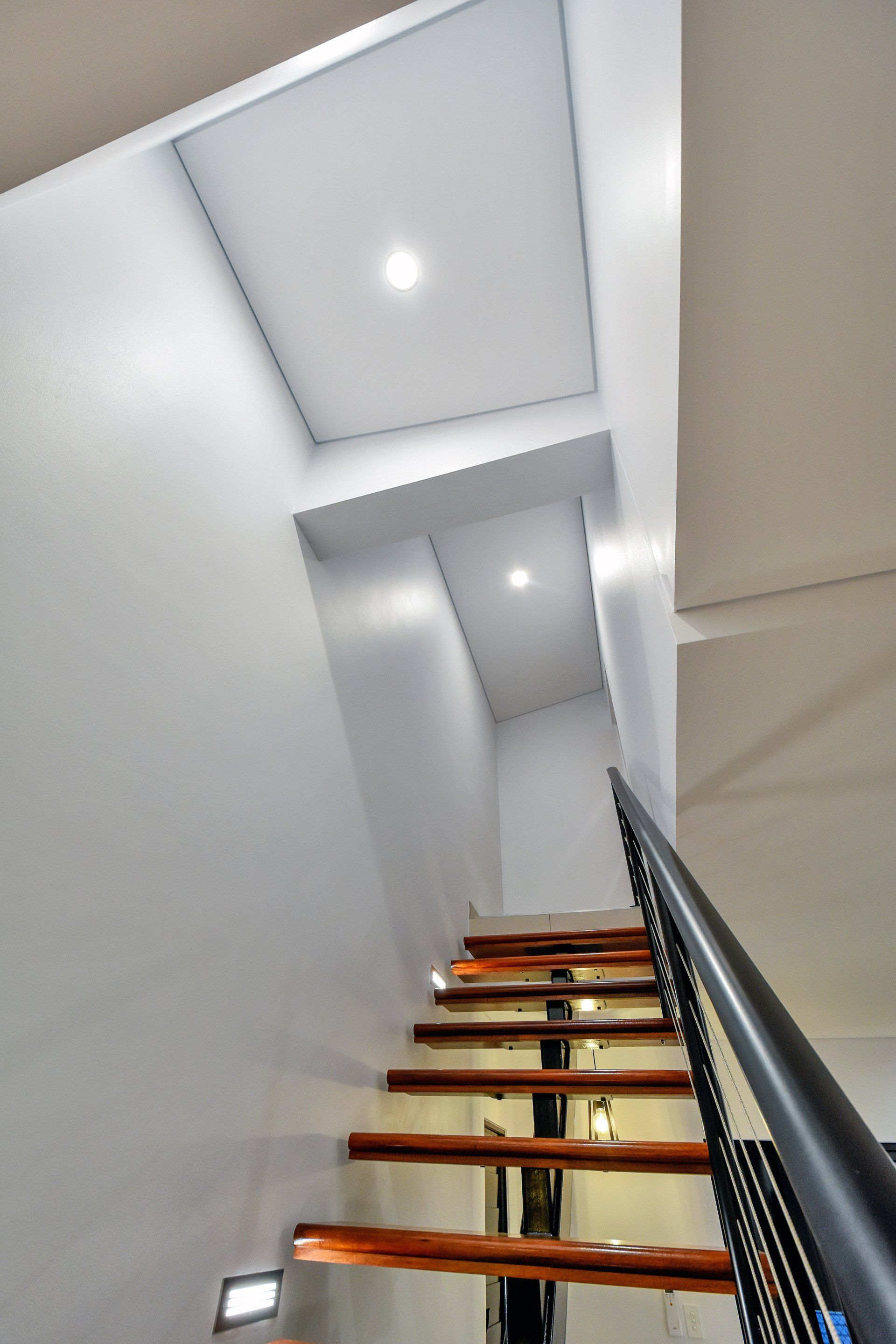 A staircase with wooden steps and a metal railing
