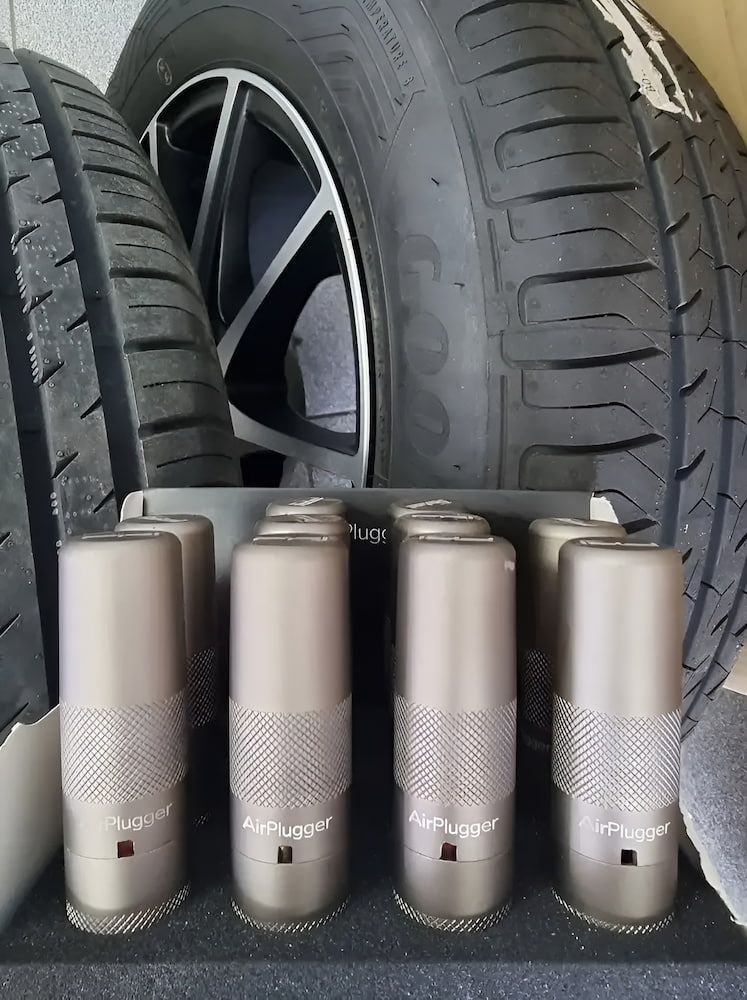 A Row Of Cans Are Sitting Next To A Car Tire — Goodyear Autocare Bowen in Bowen, QLD