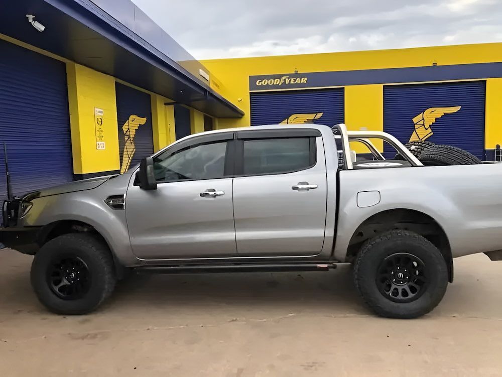 A Silver Truck Is Parked In Front Of A Yellow Building — Goodyear Autocare Bowen in Bowen, QLD