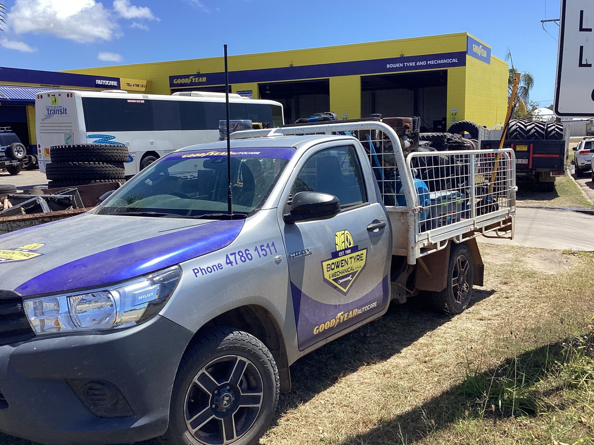 A Person Is Working On A Car Battery With A Wrench — Goodyear Autocare Bowen in Bowen, QLD