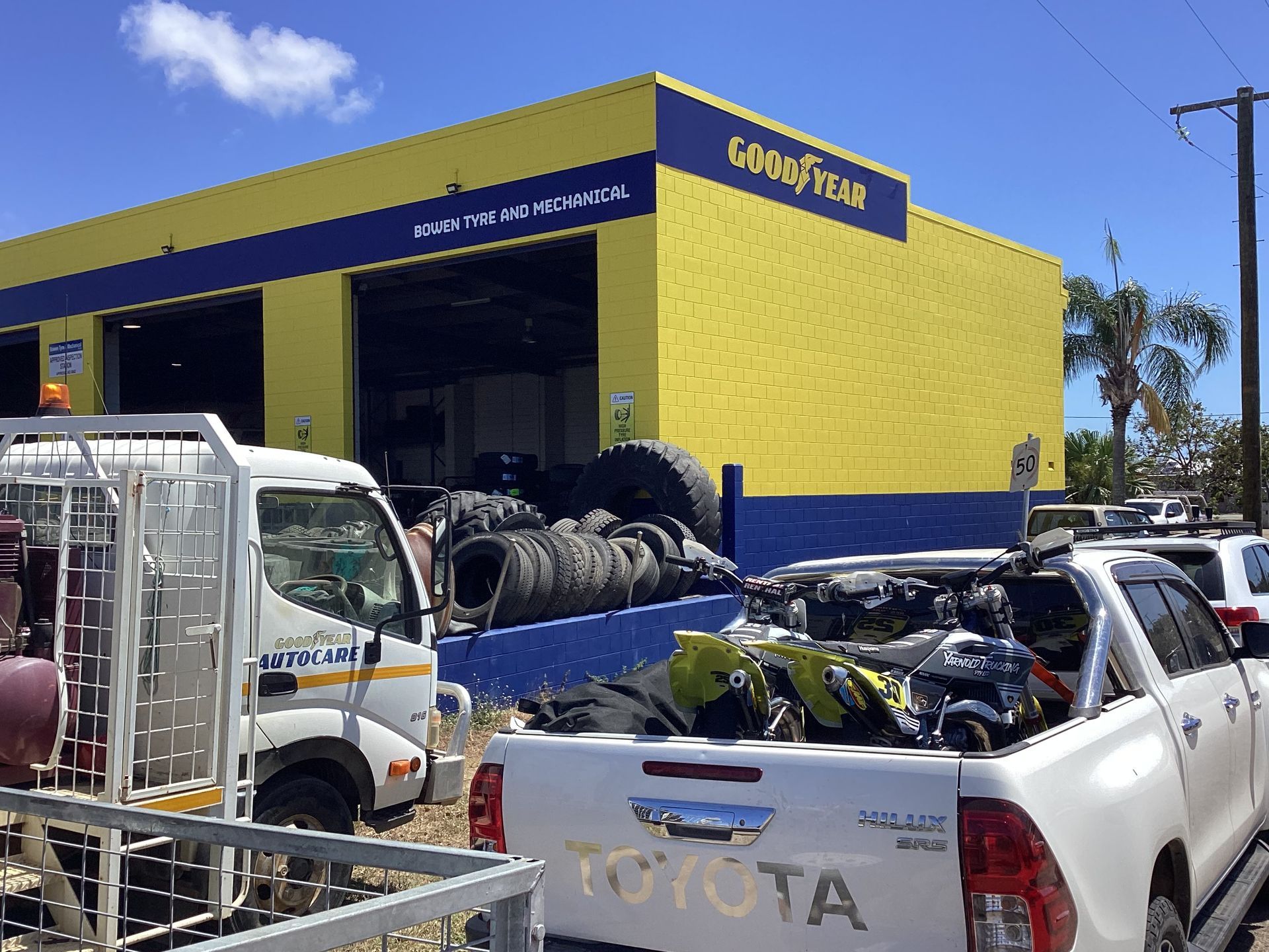 A Car Battery Is Being Charged With Red Jumper Cables — Goodyear Autocare Bowen in Bowen, QLD