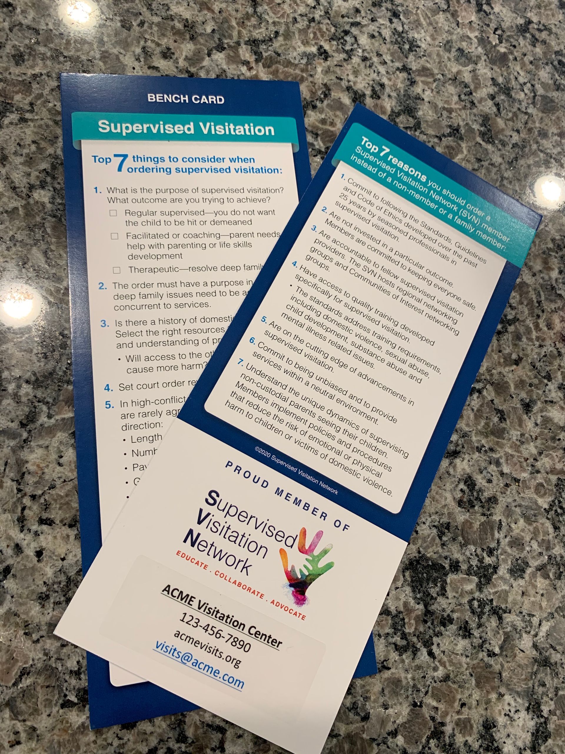 Two pamphlets are sitting on top of each other on a counter.