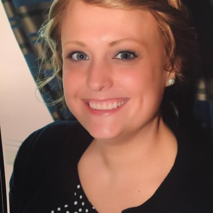 A close up of a woman 's face with a smile on her face