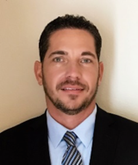 A man with a beard wearing a suit and tie