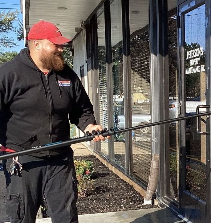 Two Men Cleaning on The Residential Lawn — Erie, PA — Peterson’s Property Maintenance