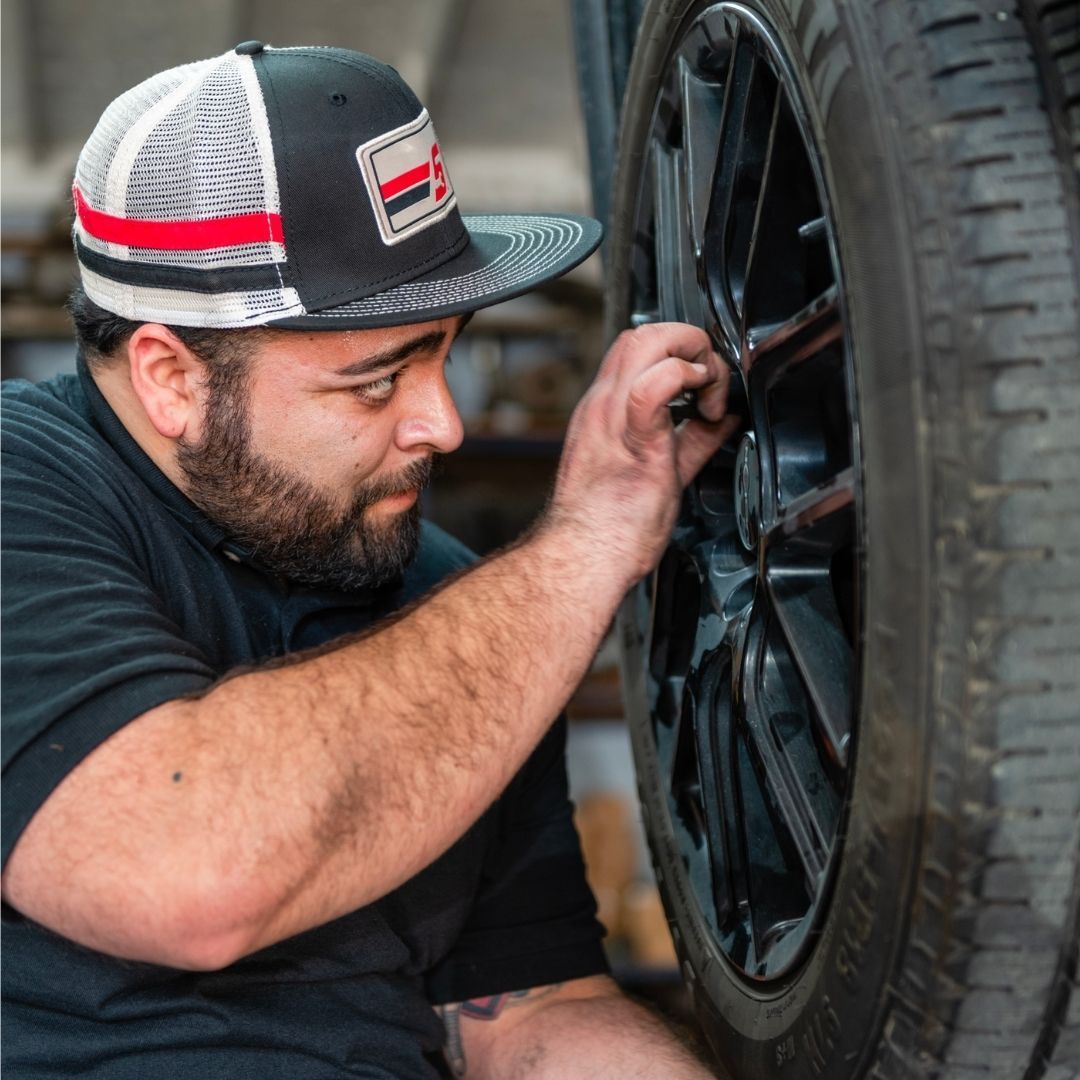 Mechanic Performing Some Form of Tire or Wheel Maintenance | Stevens Creek Muffler & Auto Repair