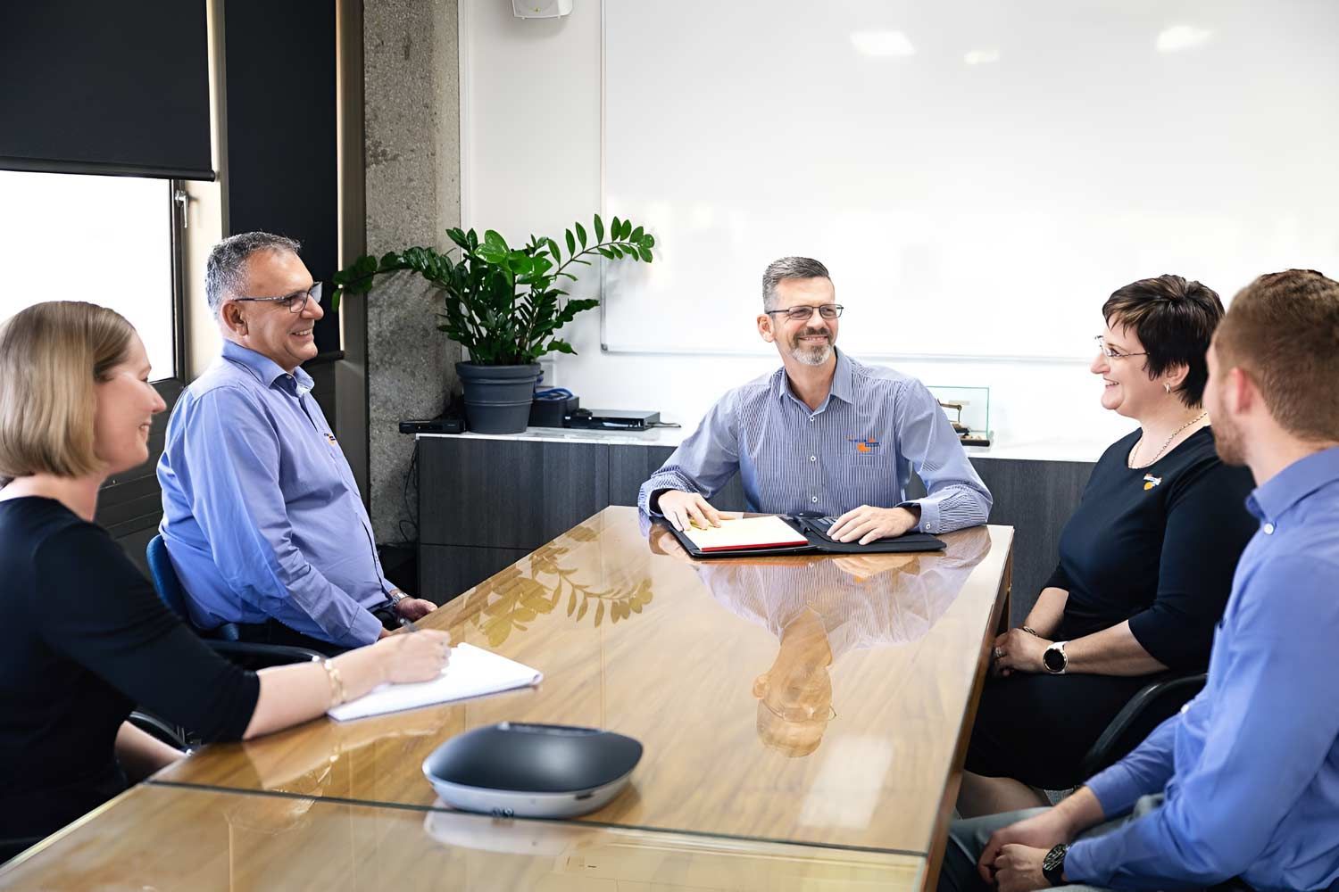 A Group Of People Are Sitting Around A Conference Table Having A Meeting — Whitson Dawson Accountants in Mackay, QLD