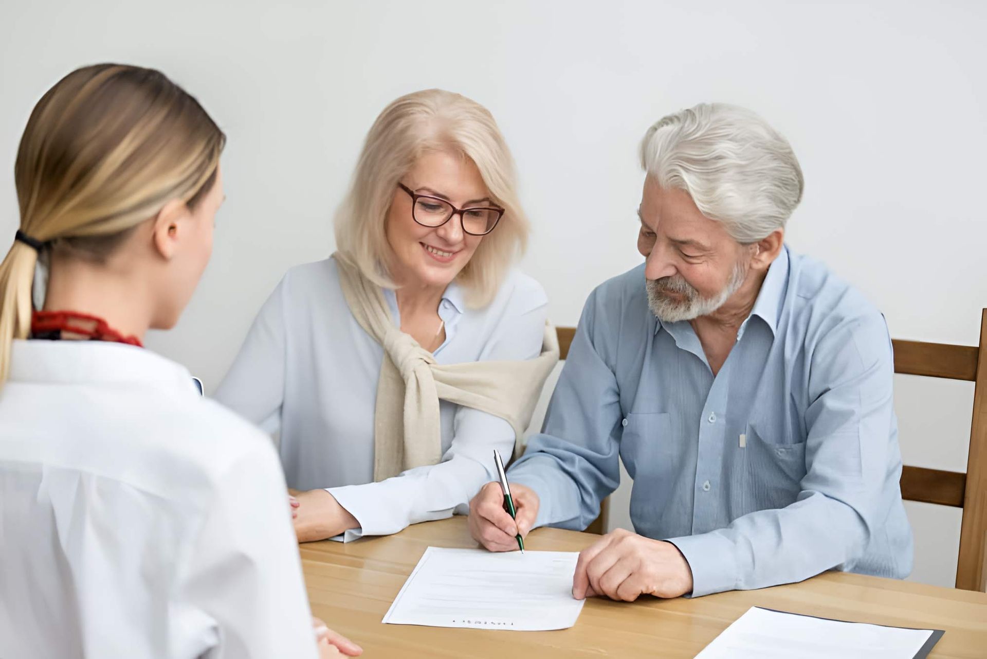 Older Couple Signing A Document — Whitson Dawson Accountants in Mackay, QLD