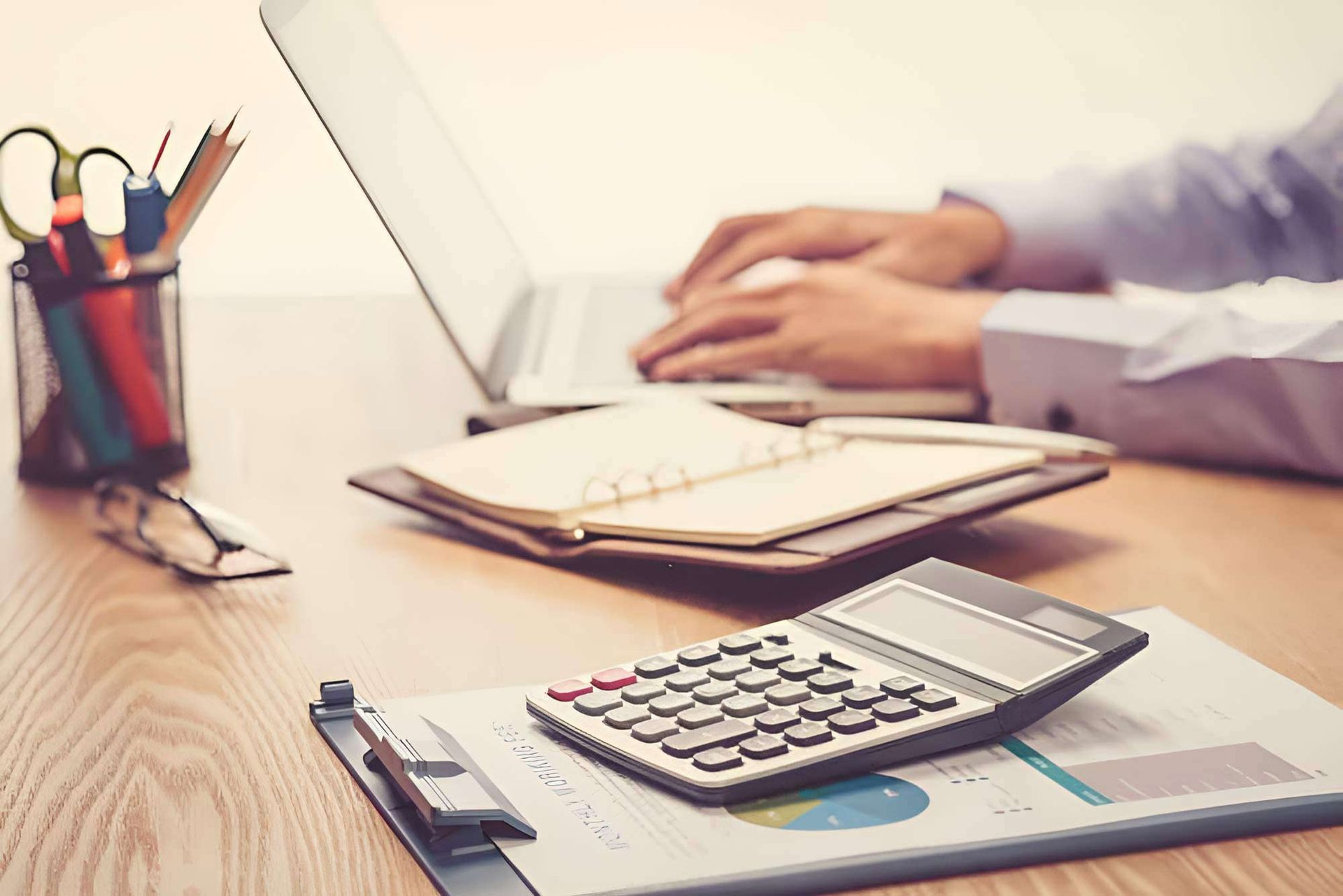 Businessman Using A Laptop And Calculator — Whitson Dawson Accountants in North Queensland