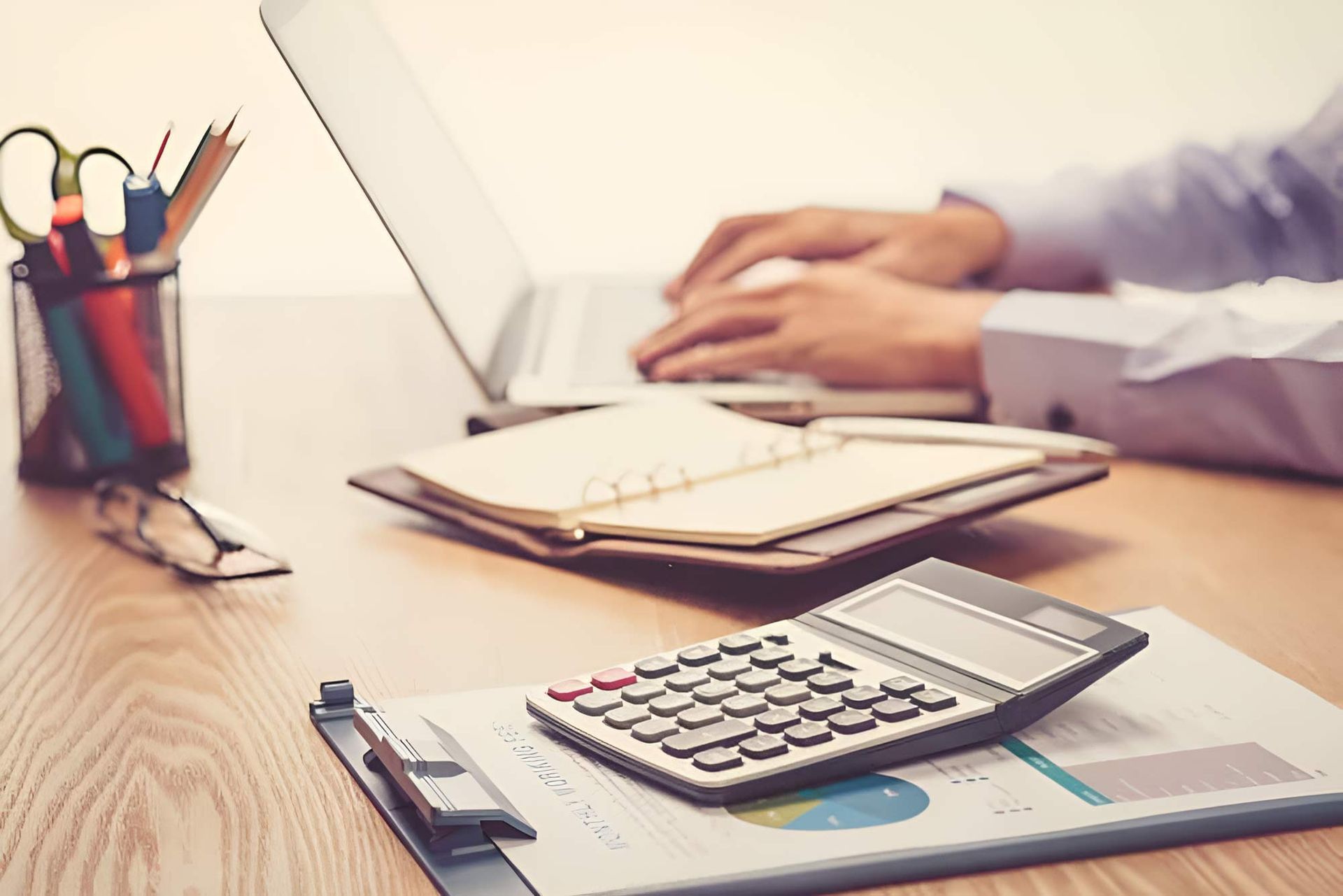 Businessman Using A Laptop With Calculator On The Side — Whitson Dawson Accountants in Mackay, QLD