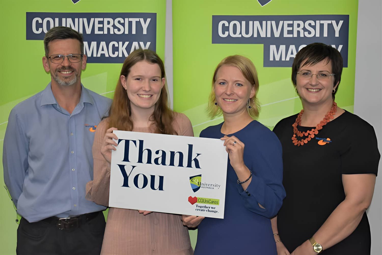 A Group Of People Holding A Thank You Sign — Whitson Dawson Accountants in Mackay, QLD