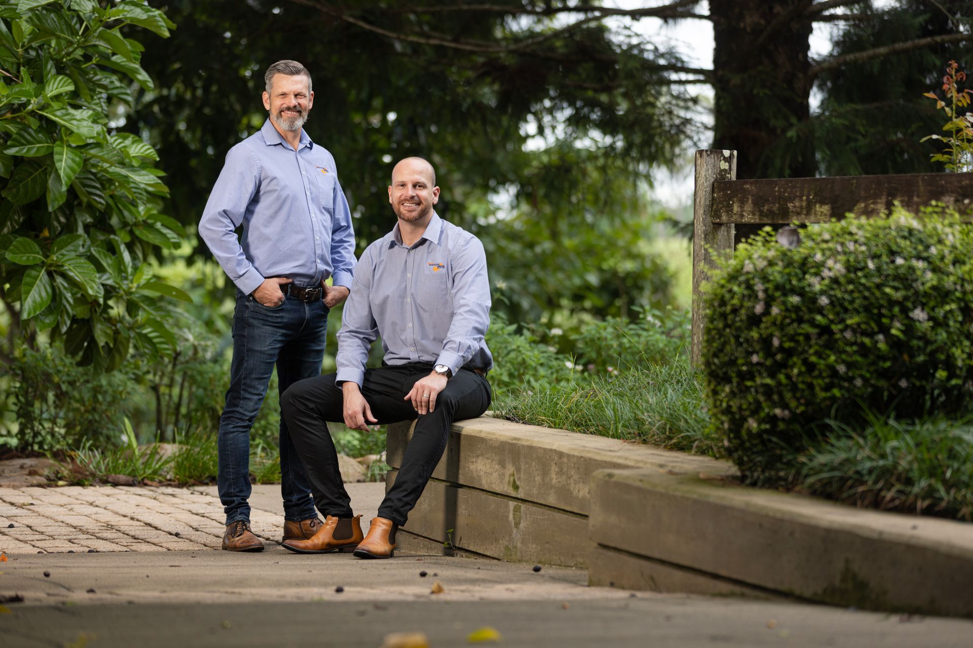 A Man Is Sitting At A Desk Talking To A Woman — Whitson Dawson Accountants in Mackay, QLD