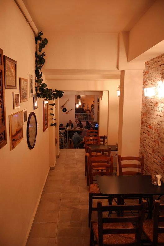 A restaurant with tables and chairs and a staircase