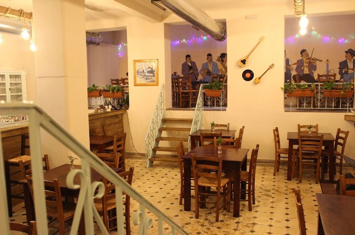 A restaurant with tables and chairs and a staircase
