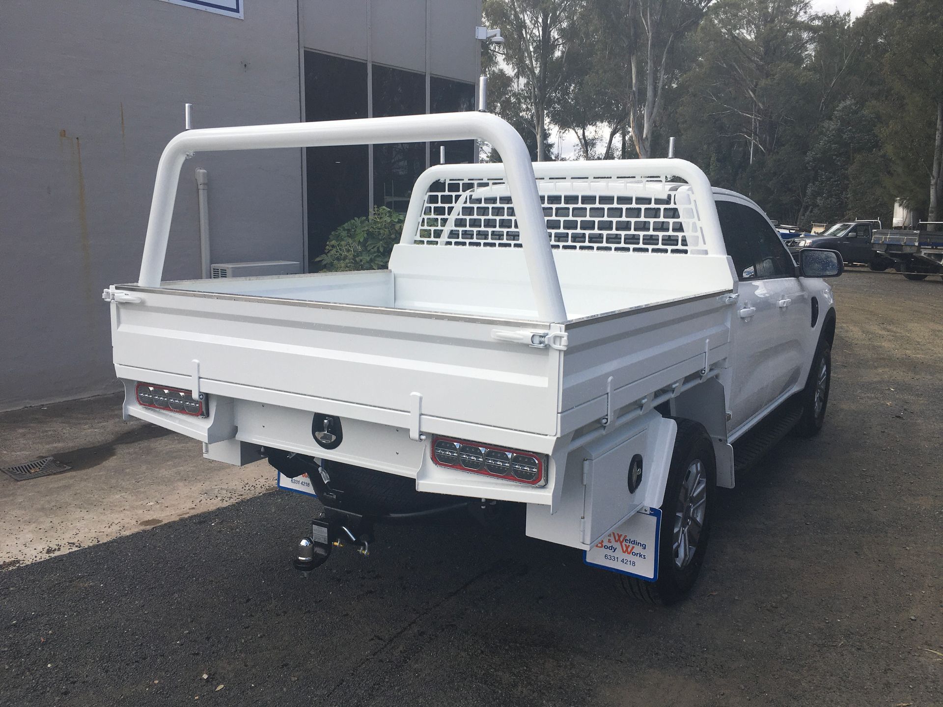 A Man Is Welding A Piece Of Metal With A Welding Machine — Bathurst Welding & Body Works In Canberra, ACT