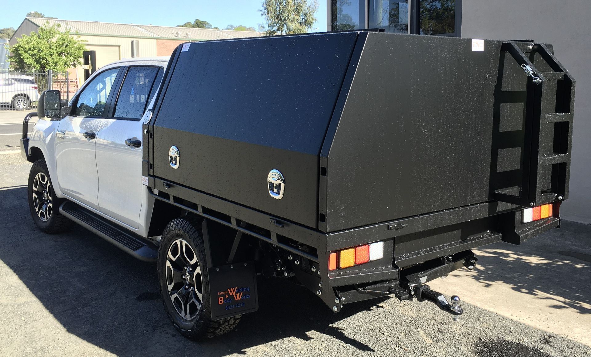 A Man Is Welding A Piece Of Metal In A Factory — Bathurst Welding & Body Works In Bathurst, NSW