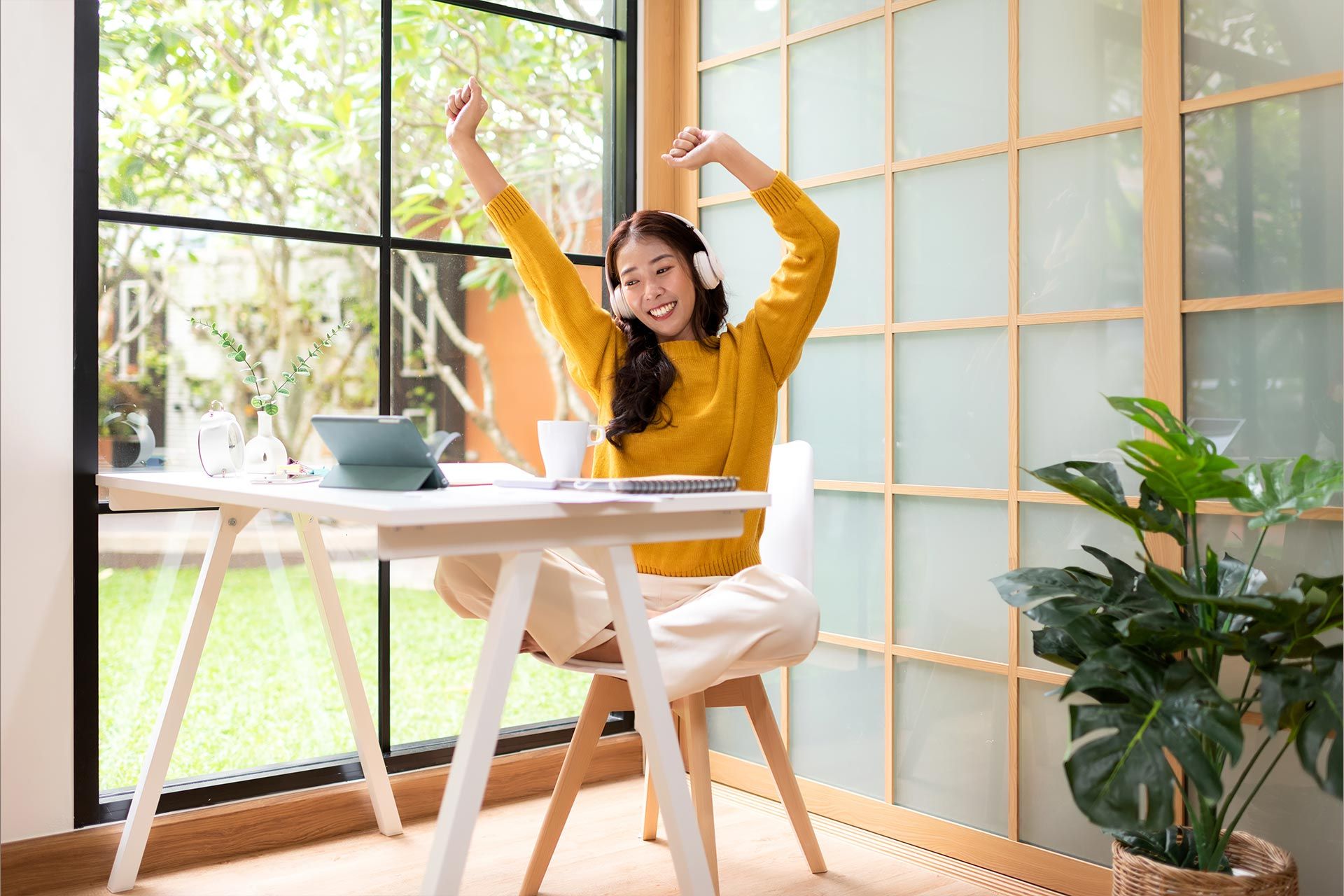 Woman celebrating at desk