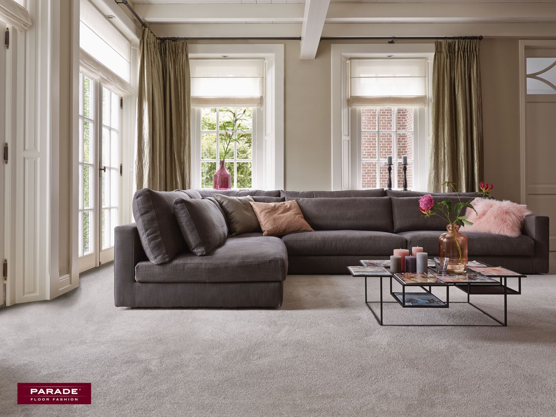 Een woonkamer met een grote hoekbank en een salontafel.