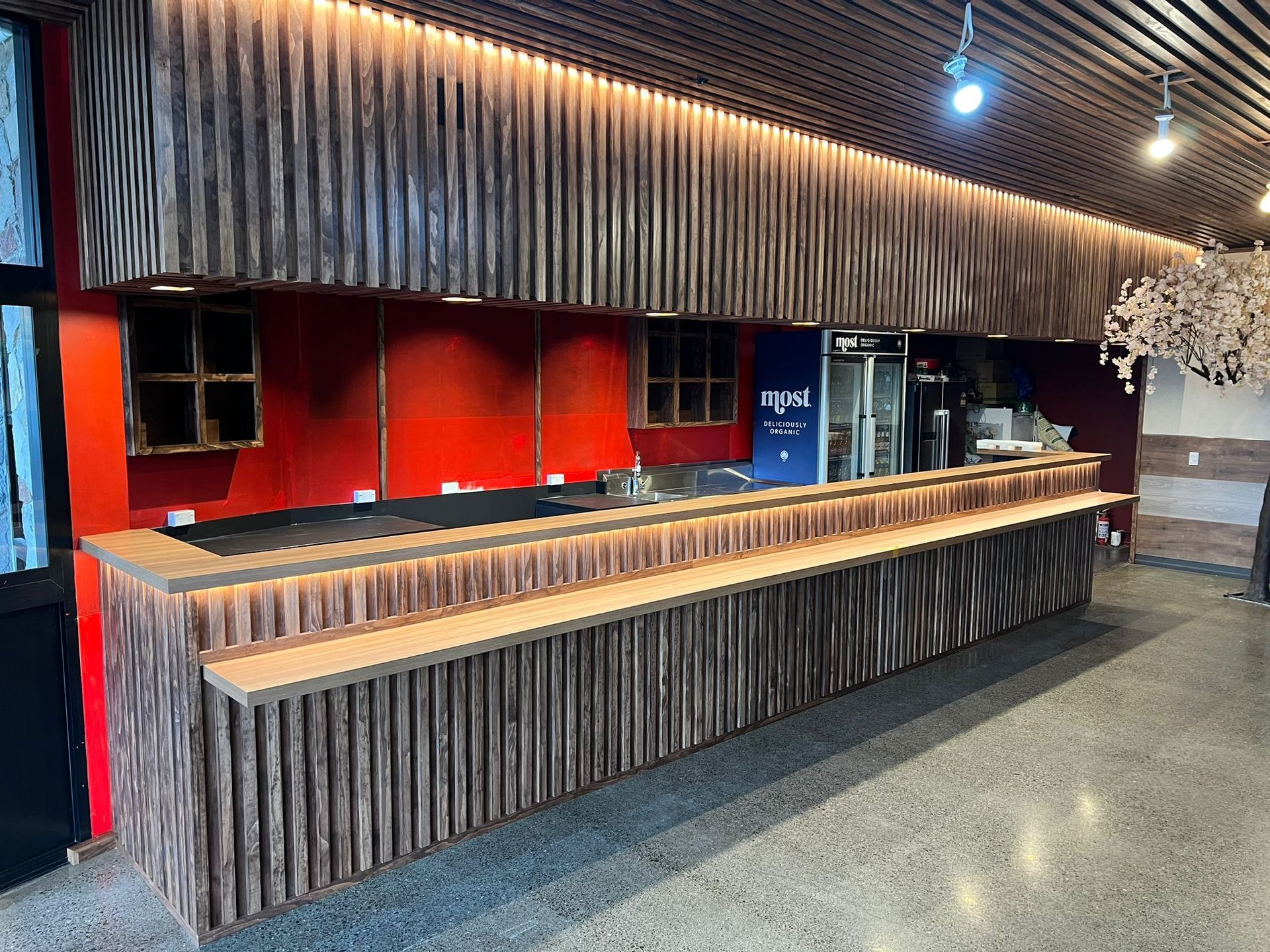 There is a long wooden counter in the middle of the room.