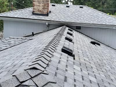 A close up of a roof with a chimney on top of it.