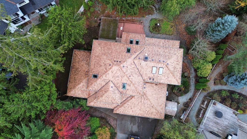 An aerial view of a large house surrounded by trees.