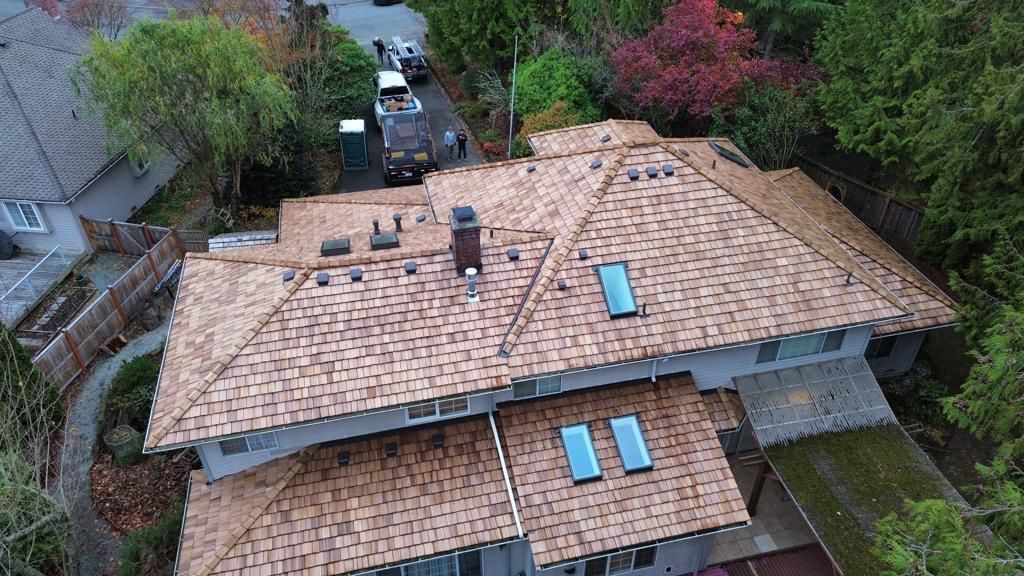 An aerial view of a house with a tiled roof and skylights.
