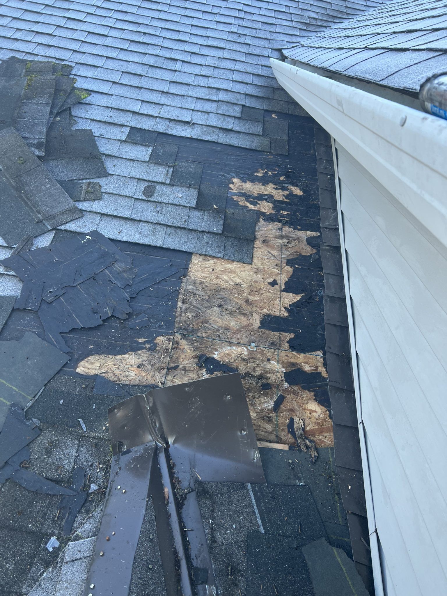 The roof of a house has been damaged by a storm.