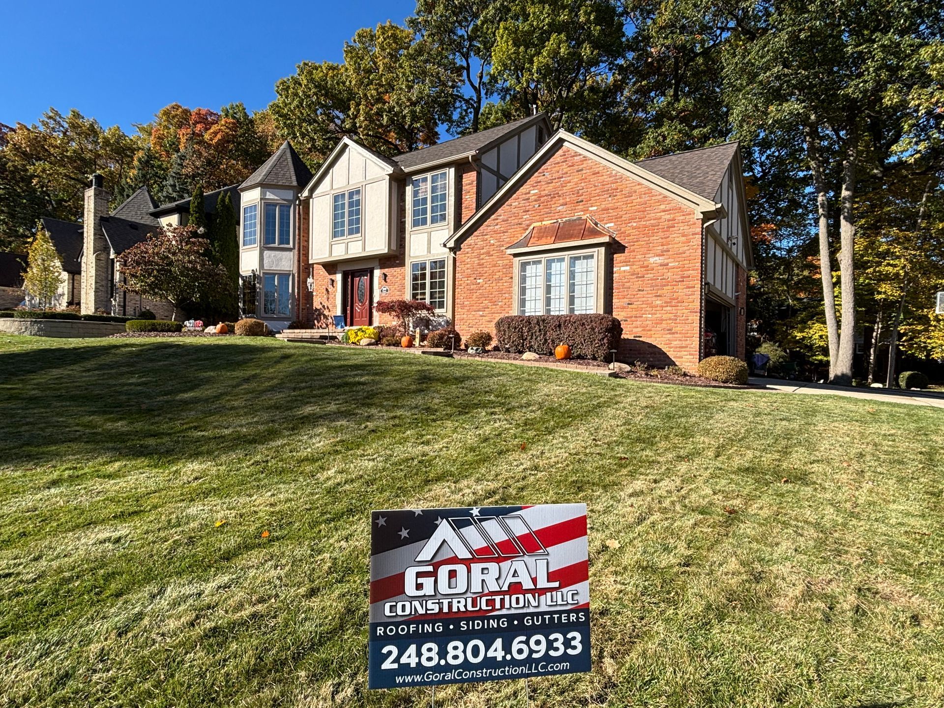 A close-up of a weathered, sloping roof covered in old, overlapping terracotta clay tiles in shades of brown and orange.