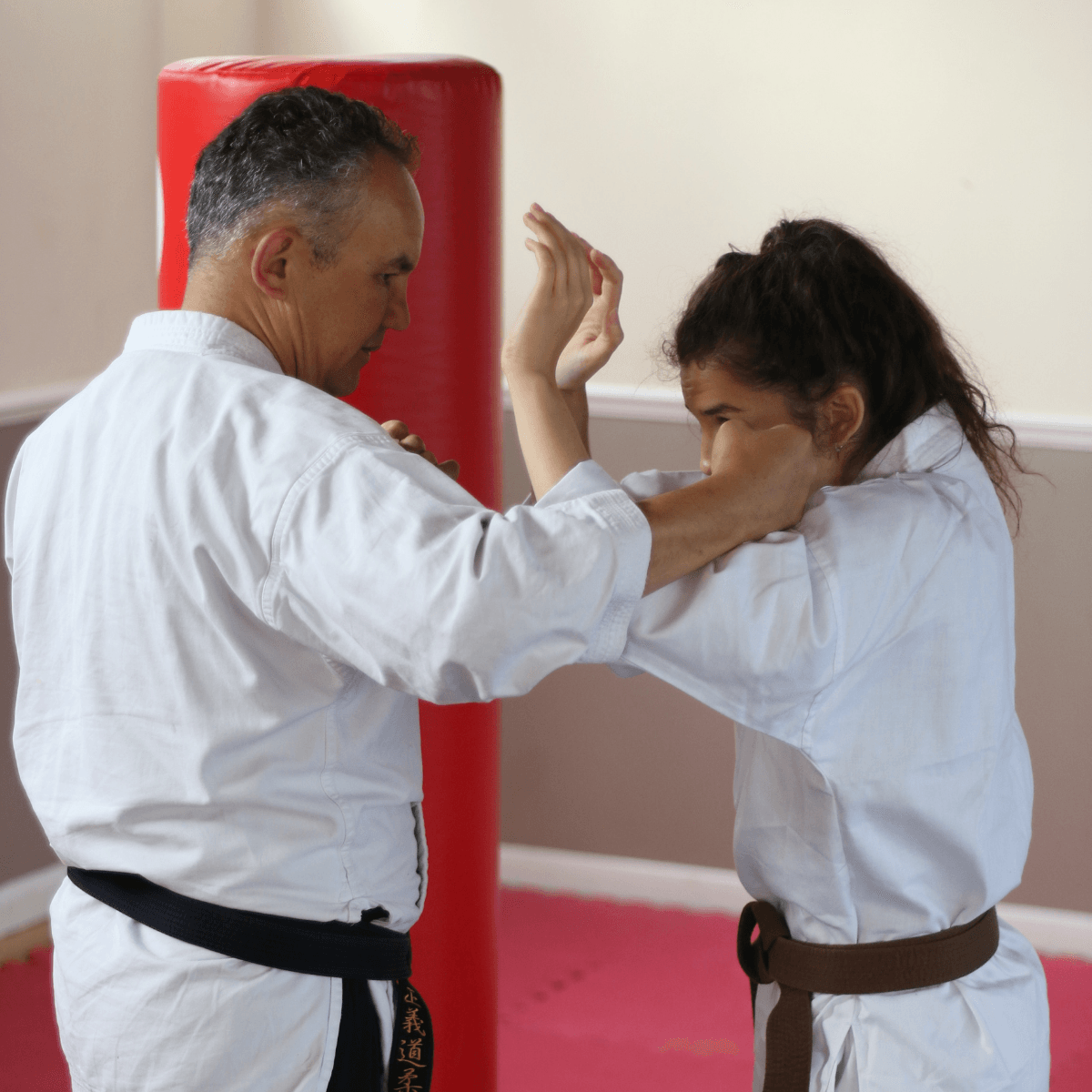 A man and a woman are practicing martial arts