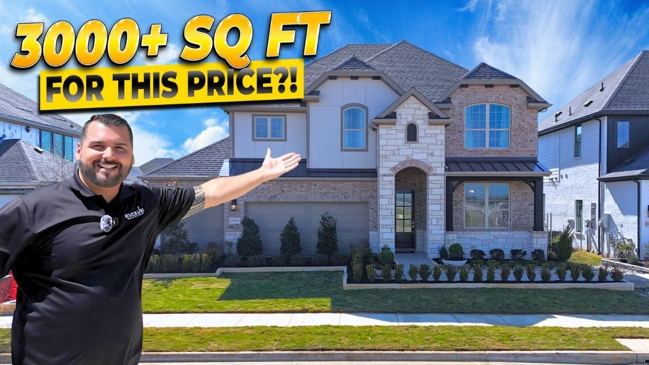 A man is standing in front of a large house.