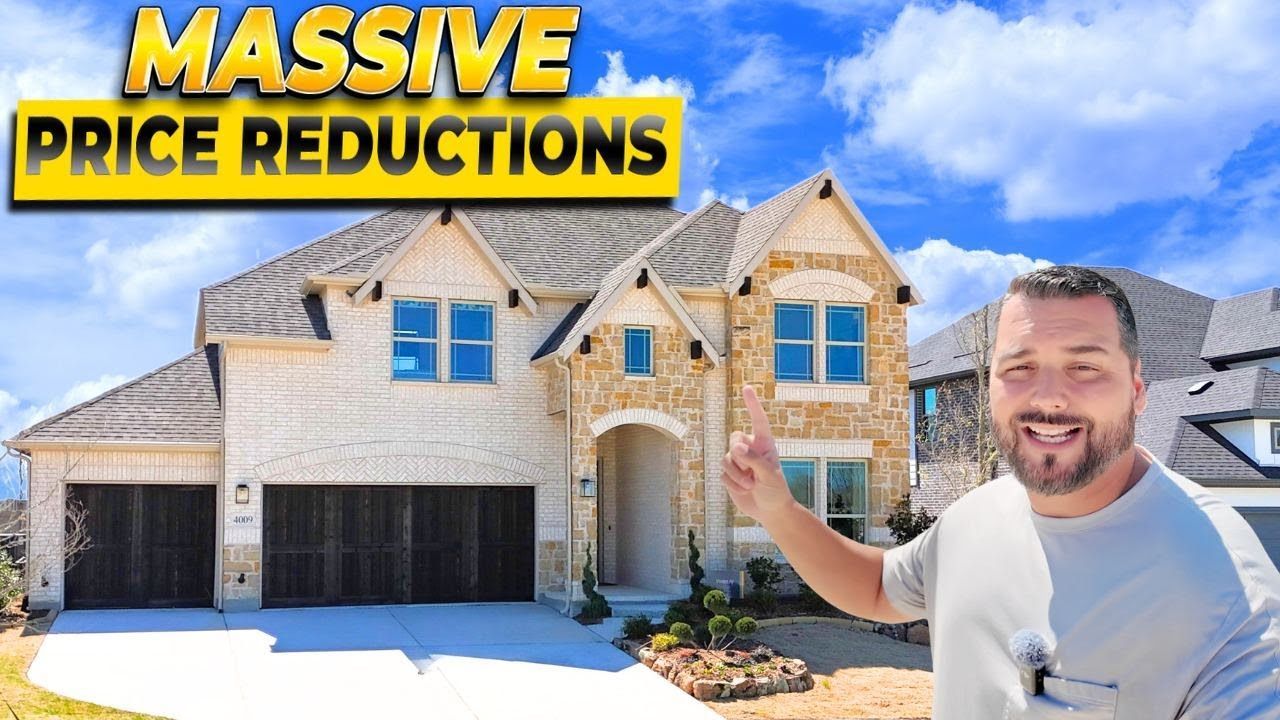 A man is standing in front of a large house.